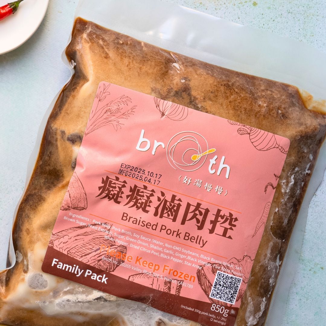 Family pack of braised pork belly with a pink label on a white surface