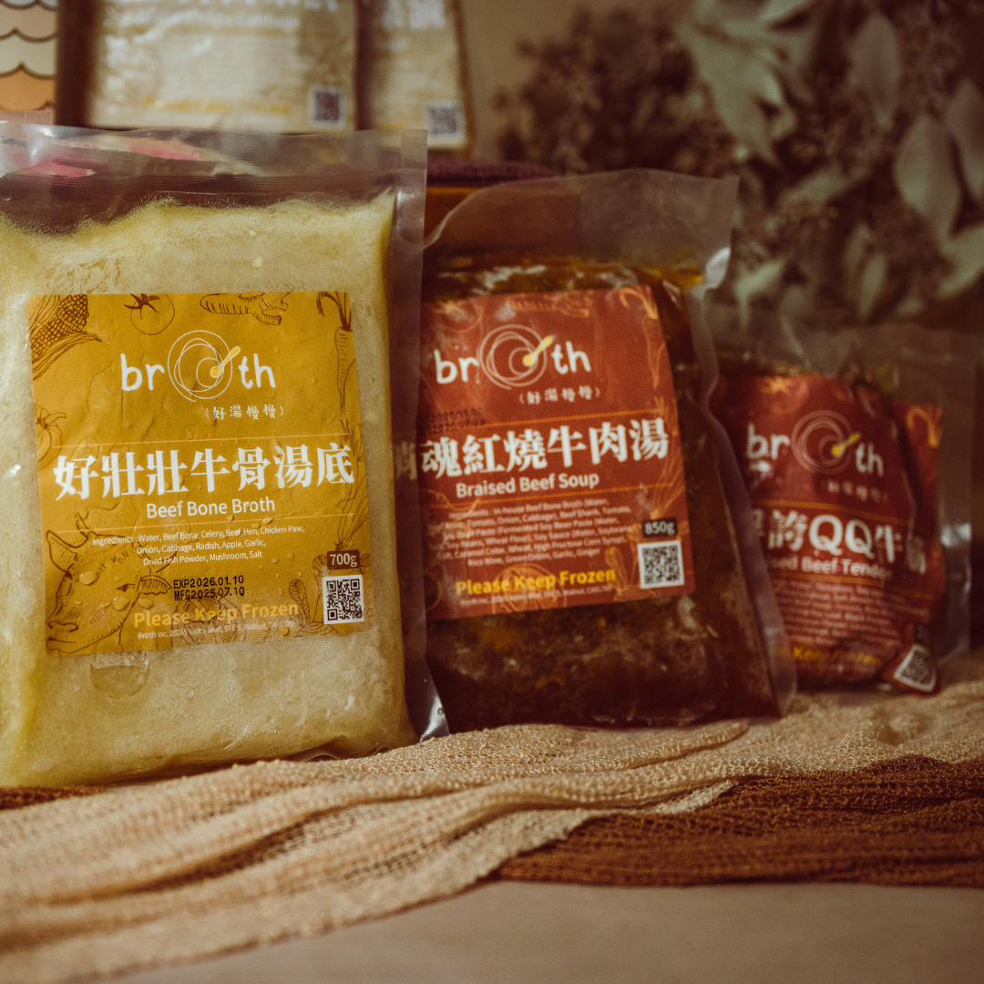 Packages of Beef Bone broth products with visible branding on a textured surface.