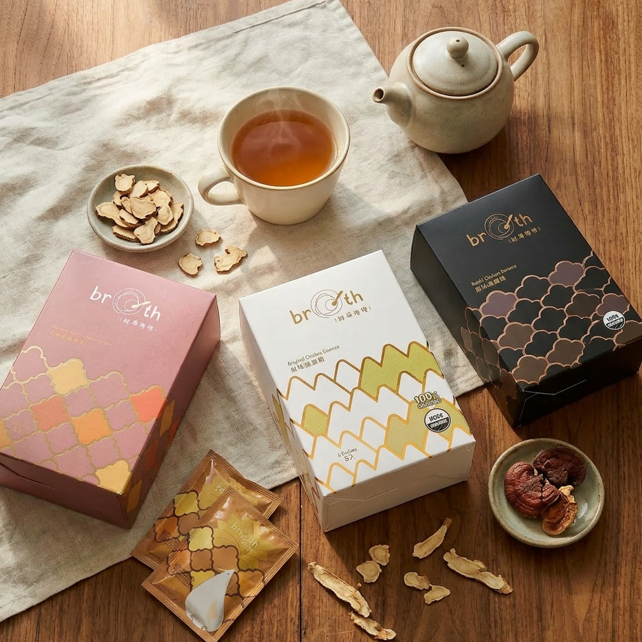 Chicken Essence packaging with a teacup, teapot, and tea leaves on a wooden surface