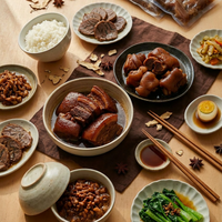 Assorted Chinese dishes including braised pork, rice, and vegetables on a wooden table.