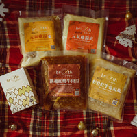 Packages of broth on a plaid fabric background with Christmas decorations