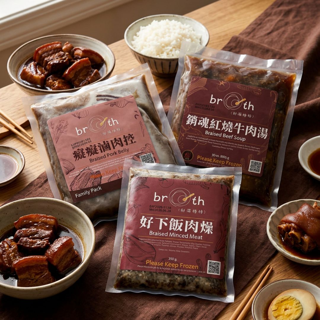 Packages of 'broth' brand frozen meals on a wooden table with bowls of food.