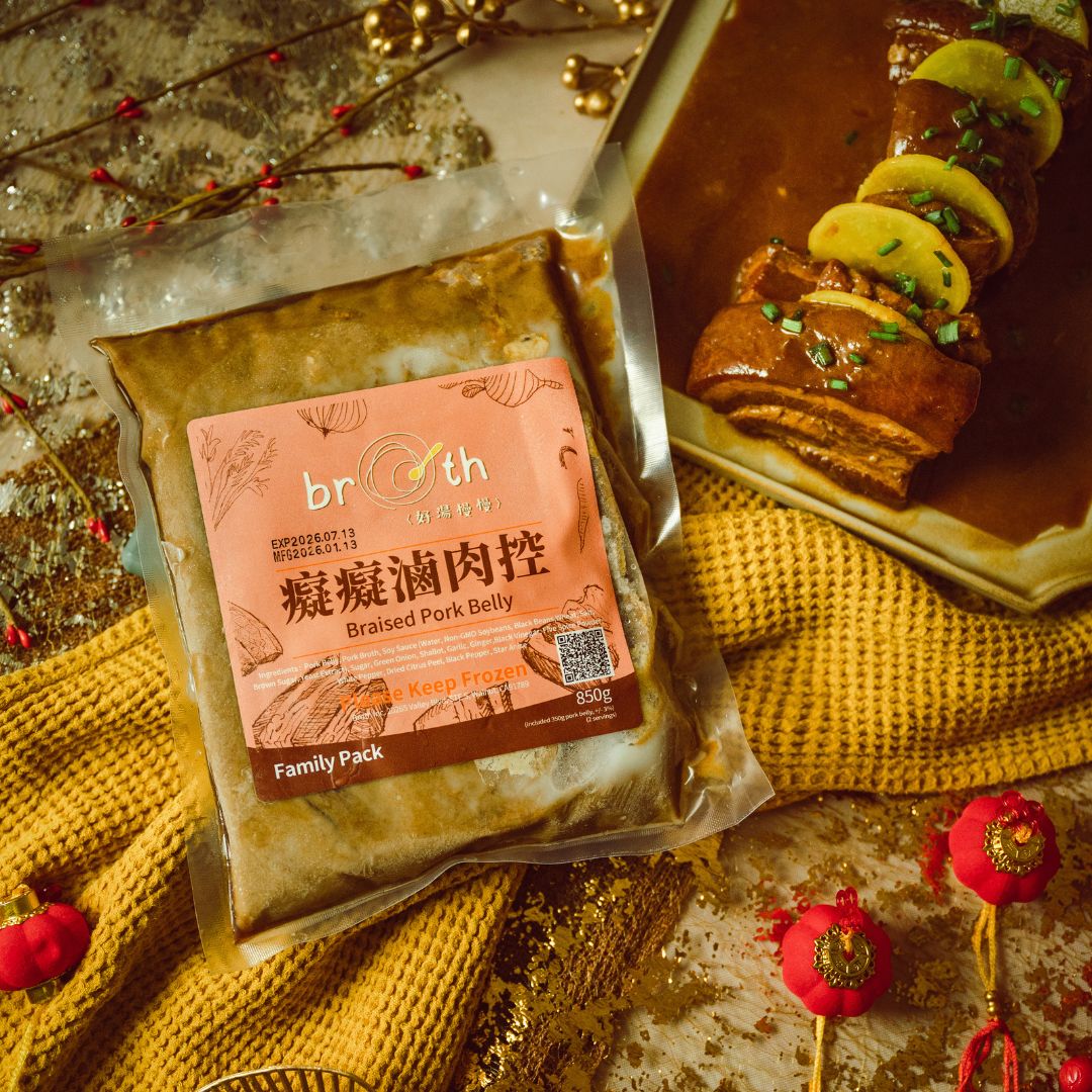 A frozen family pack of Braised Pork Belly from Broth (好湯慢慢) displayed beside a plated serving of sliced pork belly in rich sauce, styled with warm lighting and festive New Year decor.