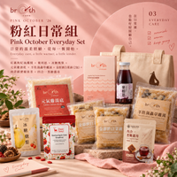 A coordinated product assortment arranged on a pink fabric surface with decorative props. The set includes multiple packaged food items and a bottle from the brand broth, including a boxed item, pouches, a jar, and a bottle labeled Everyday Care.