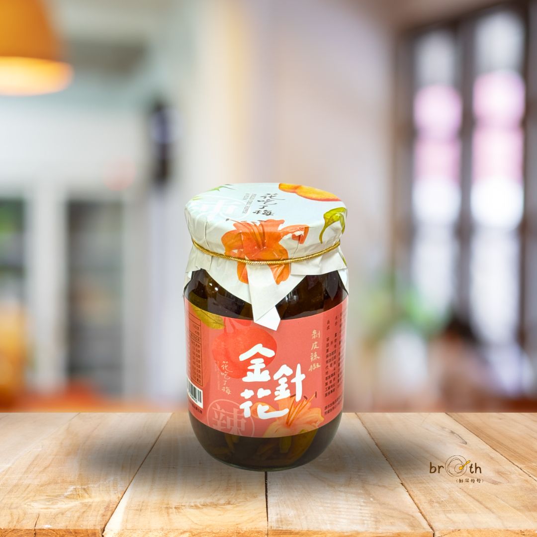 Jar of broth on a wooden table with a blurred background