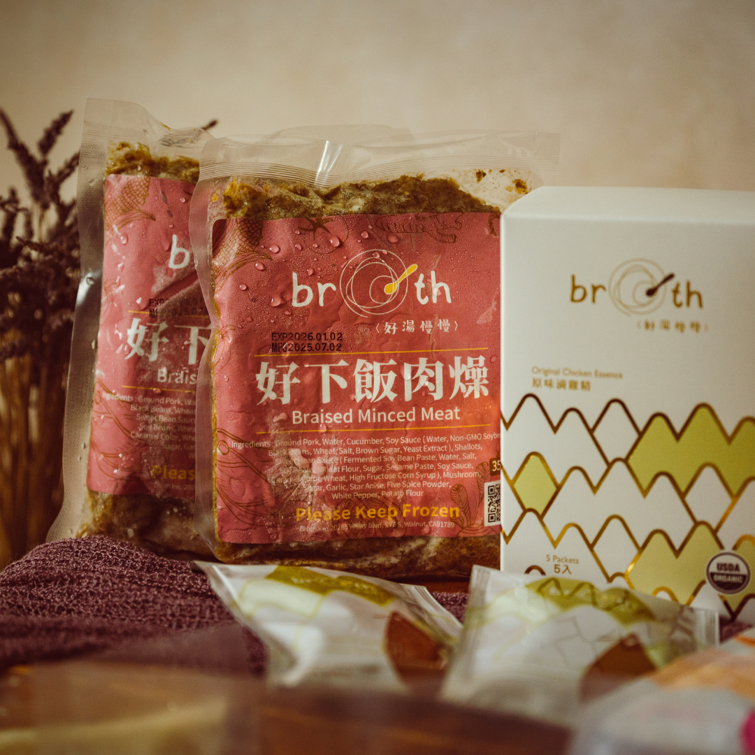 Packages of braised minced meat & Original Chicken Essence with Broth branding on a wooden surface.