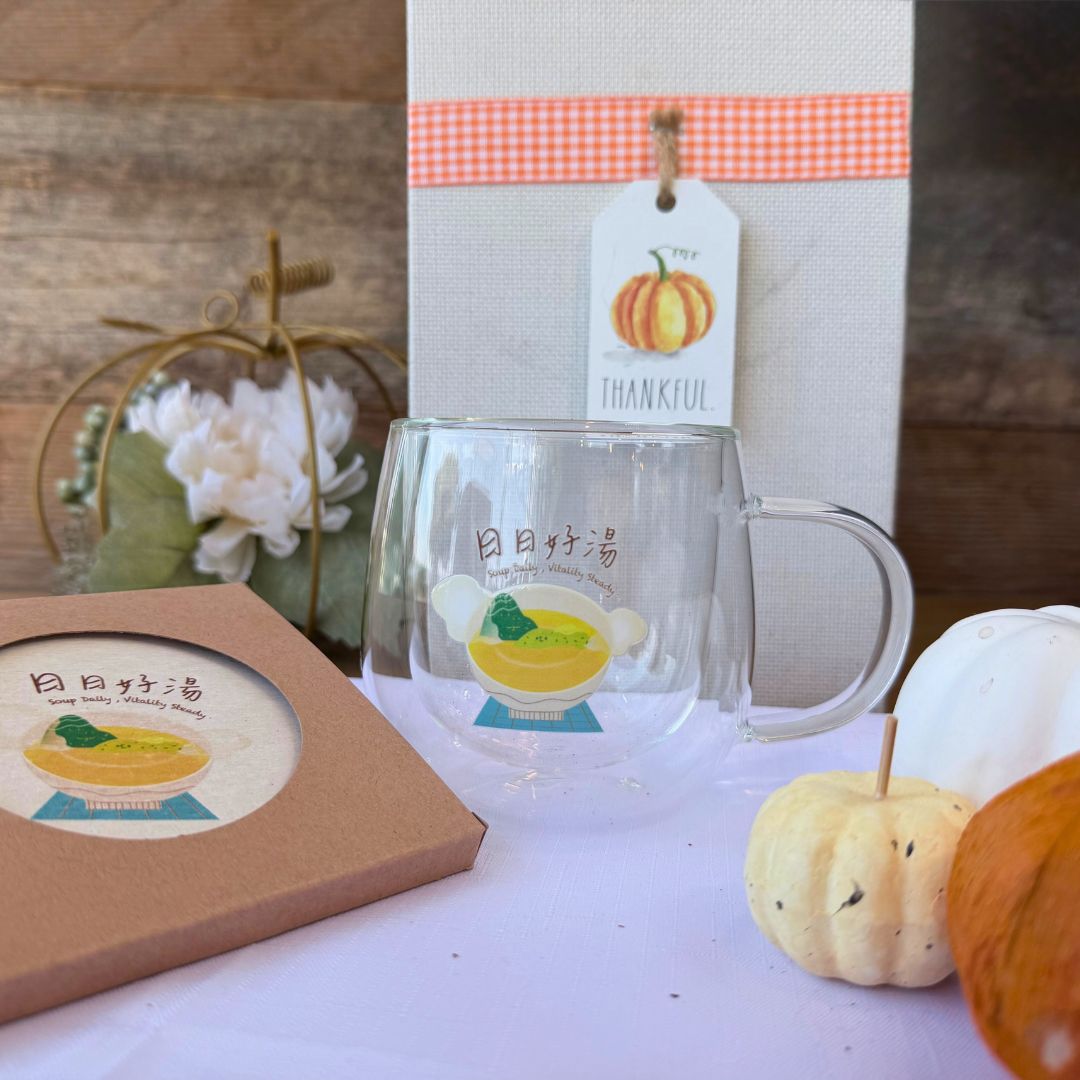 Double wall glass mug with “Soup Daily, Healthy Beauty” design displayed with matching coaster and fall decorations, featuring mini pumpkins and a thankful tag.